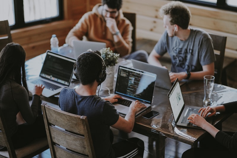 Self-employed professionals working at laptops in a modern workspace